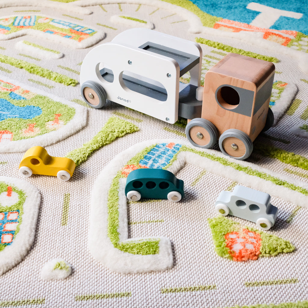 Janod Car Carrier with vehicles on ivi Mini City Rug UrbanBaby